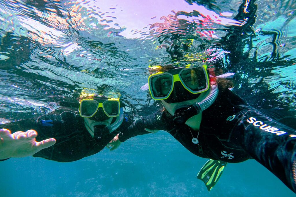 Snorkelers exploring the vibrant coral gardens of Blue Lagoon.