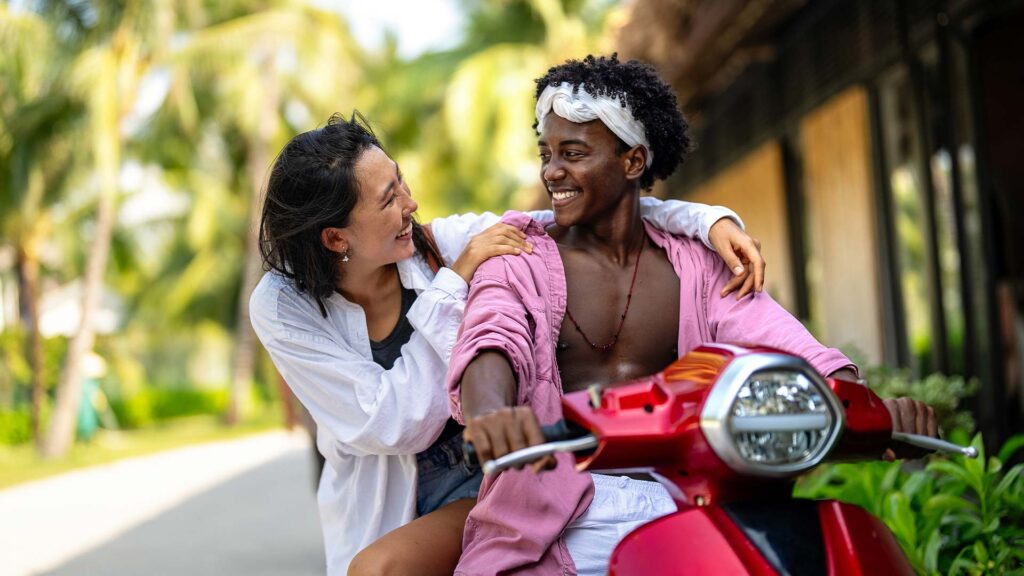 Tourists choosing scooter along Bali’s coast.