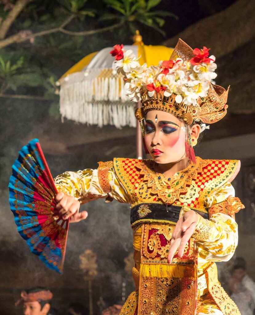 Close-up of a dancer’s fingers in Balinese dance class, showcasing costume and hand gestures